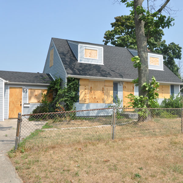 home with boarded up windows